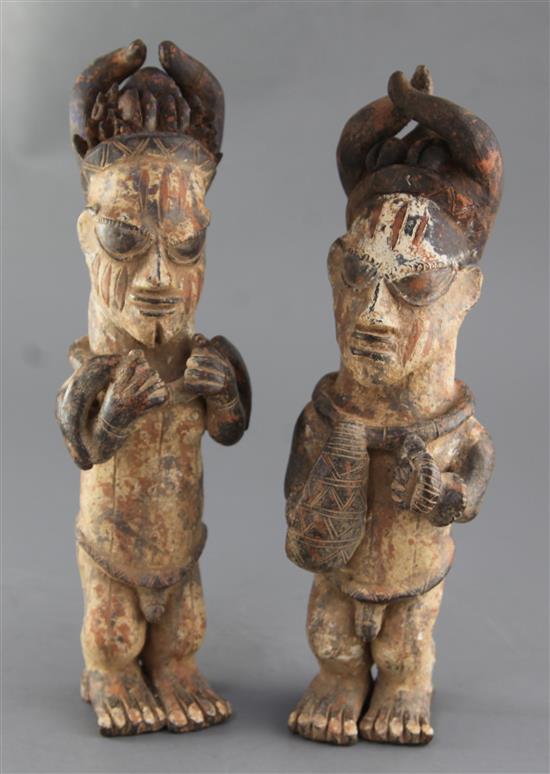 A pair of Ibo People of Nigeria painted terracotta figures, 34cm